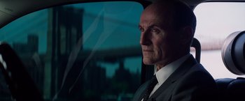 Movie still from “The Amazing Spider-Man 2” (2014), directed by Marc Webb – A man wearing a suit and tie sitting in a car; Close Up shot, Over the shoulder angle