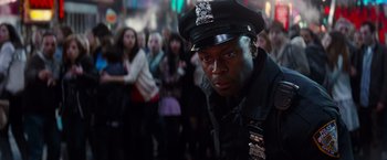 Movie still from “The Amazing Spider-Man 2” (2014), directed by Marc Webb – A man in a police officer's uniform in front of a group of onlookers; Close Up shot, Over the shoulder angle