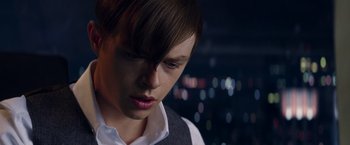 Movie still from “The Amazing Spider-Man 2” (2014), directed by Marc Webb – A young man with short brown hair wearing a white shirt; Close Up shot, Over the shoulder angle