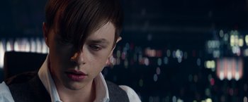 Movie still from “The Amazing Spider-Man 2” (2014), directed by Marc Webb – A young man with a short hair cut looks down at the camera; Close Up shot, Over the shoulder angle