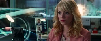 Movie still from “The Amazing Spider-Man 2” (2014), directed by Marc Webb – A woman sitting in front of a mirror with pictures on it; Close Up shot, Over the shoulder angle