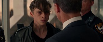 Movie still from “The Amazing Spider-Man 2” (2014), directed by Marc Webb – A young man looking into a mirror while standing next to an older man; Close Up shot, Over the shoulder angle