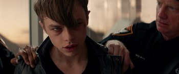Movie still from “The Amazing Spider-Man 2” (2014), directed by Marc Webb – A young man is looking down at the camera; Close Up shot, Over the shoulder angle