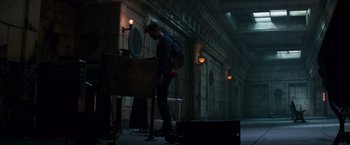 Movie still from “The Amazing Spider-Man 2” (2014), directed by Marc Webb – A man with a backpack standing next to a suitcase; Wide shot, Low angle