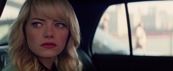 Movie still from “The Amazing Spider-Man 2” (2014), directed by Marc Webb – A woman sitting in the back seat of a car looking out the window; Close Up shot, Over the shoulder angle