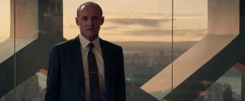 Movie still from “The Amazing Spider-Man 2” (2014), directed by Marc Webb – A man in a suit and tie standing in front of a window; Medium shot, Low angle