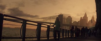 Movie still from “The Amazing Spider-Man 2” (2014), directed by Marc Webb – A woman standing next to a railing near a bridge; Extreme Wide shot, Low angle