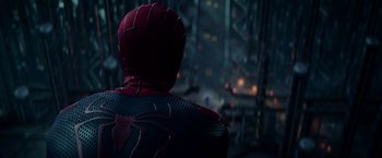 Movie still from “The Amazing Spider-Man 2” (2014), directed by Marc Webb – A man in a spider - man costume looking out a window; Close Up shot, Over the shoulder angle