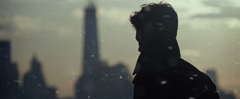 Movie still from “The Amazing Spider-Man 2” (2014), directed by Marc Webb – A person standing in front of the eiffel tower in the snow; Close Up shot, Over the shoulder angle