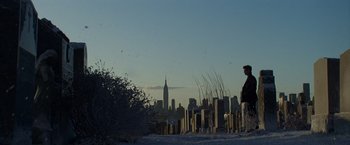Movie still from “The Amazing Spider-Man 2” (2014), directed by Marc Webb – A man standing in front of a city skyline at dusk; Extreme Wide shot, Low angle