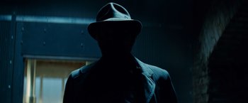 Movie still from “The Amazing Spider-Man 2” (2014), directed by Marc Webb – A man wearing a hat and a suit; Close Up shot, Low angle