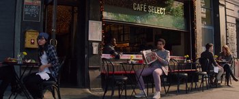 Movie still from “The Amazing Spider-Man 2” (2014), directed by Marc Webb – A man sitting at a table reading a newspaper; Wide shot, Over the shoulder angle