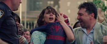 Movie still from “The Amazing Spider-Man 2” (2014), directed by Marc Webb – A woman holding a child in a spider - man costume; Close Up shot, Over the shoulder angle
