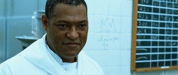 A person wearing a lab coat in a room