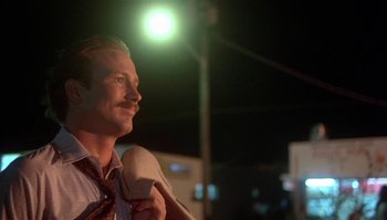 Movie still from “Body Heat” (1981), directed by Lawrence Kasdan – A person wearing a suit and tie; Close Up shot, Low angle
