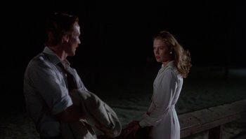 Movie still from “Body Heat” (1981), directed by Lawrence Kasdan – A man and a woman standing next to each other; Medium shot, Over the shoulder angle