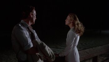 Movie still from “Body Heat” (1981), directed by Lawrence Kasdan – A man and a woman standing next to each other; Medium shot, Over the shoulder angle