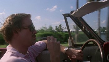 Movie still from “Body Heat” (1981), directed by Lawrence Kasdan – A man sitting in the driver's seat of a car; Close Up shot, Low angle