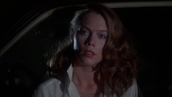 Movie still from “Body Heat” (1981), directed by Lawrence Kasdan – A person with long hair in a car; Close Up shot, Low angle