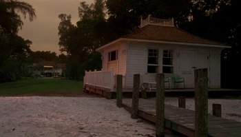 Movie still from “Body Heat” (1981), directed by Lawrence Kasdan – A white house sitting next to a sandy beach; Extreme Wide shot, Low angle