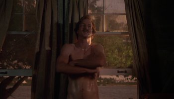 Movie still from “Body Heat” (1981), directed by Lawrence Kasdan – A shirtless man standing in front of a window; Medium shot, Low angle