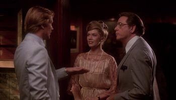 Movie still from “Body Heat” (1981), directed by Lawrence Kasdan – Two men and a woman standing next to each other; Medium shot, Over the shoulder angle