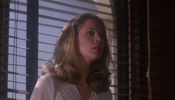 Movie still from “Body Heat” (1981), directed by Lawrence Kasdan – A woman with long blonde hair standing in front of a window; Close Up shot, Low angle