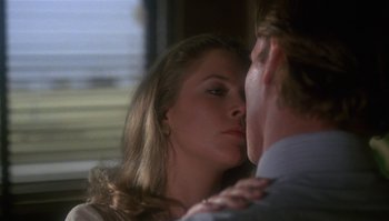 Movie still from “Body Heat” (1981), directed by Lawrence Kasdan – A man and a woman kissing in front of a window; Close Up shot, Over the shoulder angle