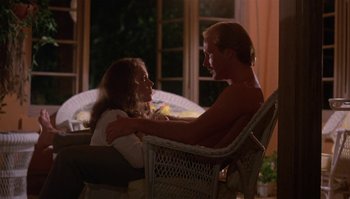 Movie still from “Body Heat” (1981), directed by Lawrence Kasdan – A man and a woman sitting on a chair; Medium shot, Over the shoulder angle