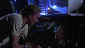 Movie still from “Body Heat” (1981), directed by Lawrence Kasdan – A man and a woman sitting in the back seat of a car; Medium shot, Low angle