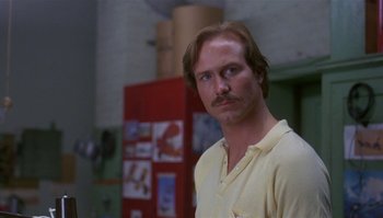 Movie still from “Body Heat” (1981), directed by Lawrence Kasdan – A man in a yellow shirt is standing in front of a red refrigerator; Close Up shot, Low angle