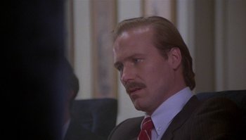 Movie still from “Body Heat” (1981), directed by Lawrence Kasdan – A person wearing a suit and tie; Close Up shot, Low angle