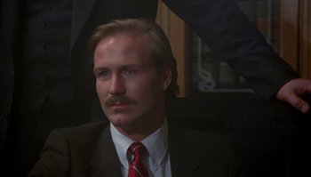 Movie still from “Body Heat” (1981), directed by Lawrence Kasdan – A person wearing a suit and tie; Close Up shot, Over the shoulder angle