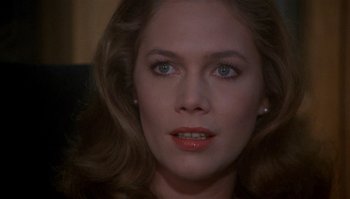 Movie still from “Body Heat” (1981), directed by Lawrence Kasdan – A woman's face in a dark room; Close Up shot, Over the shoulder angle