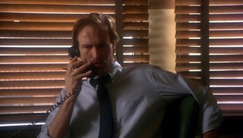 Movie still from “Body Heat” (1981), directed by Lawrence Kasdan – A man sitting in a chair talking on a phone; Close Up shot, Low angle