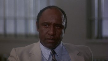 Movie still from “Body Heat” (1981), directed by Lawrence Kasdan – A person wearing a suit and tie; Close Up shot, Low angle