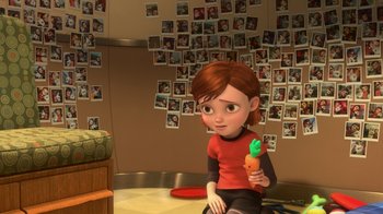 Movie still from “Bolt” (2008), directed by Chris Williams – A girl sitting on the floor holding a carrot; Wide shot, Over the shoulder angle