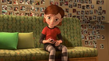Movie still from “Bolt” (2008), directed by Chris Williams – A little girl sitting on a couch holding a wii controller; Medium shot, High angle