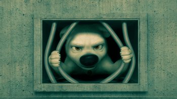 Movie still from “Bolt” (2008), directed by Chris Williams – An image of a dog inside a cage; Medium shot, High angle