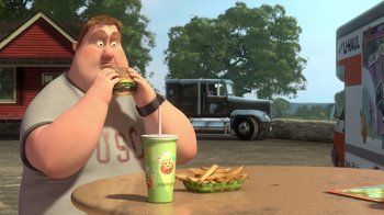 Movie still from “Bolt” (2008), directed by Chris Williams – An animated character eating a sandwich and fries; Medium shot, High angle
