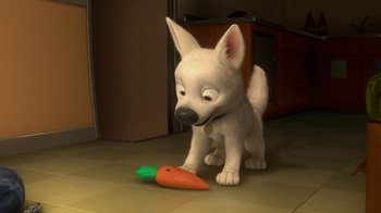 Movie still from “Bolt” (2008), directed by Chris Williams – A white dog is playing with a toy carrot; Medium shot, High angle
