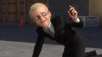 Movie still from “Bolt” (2008), directed by Chris Williams – An animated man in a black suit is holding a cell phone; Medium shot, High angle