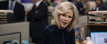 Movie still from “Bombshell” (2019), directed by Jay Roach – A woman with blonde hair wearing a black jacket; Close Up shot, Over the shoulder angle