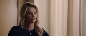 Movie still from “Bombshell” (2019), directed by Jay Roach – A woman with long blonde hair wearing a blue shirt; Close Up shot, Over the shoulder angle