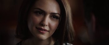 Movie still from “Bombshell” (2019), directed by Jay Roach – A woman's face in a dark room; Close Up shot, Over the shoulder angle