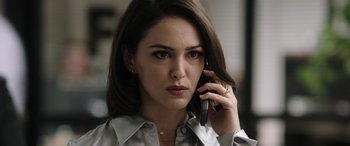 Movie still from “Bombshell” (2019), directed by Jay Roach – A woman talking on a cell phone while wearing a white shirt; Close Up shot, Over the shoulder angle