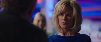 Movie still from “Bombshell” (2019), directed by Jay Roach – A woman with blonde hair and a blue shirt; Close Up shot, Over the shoulder angle