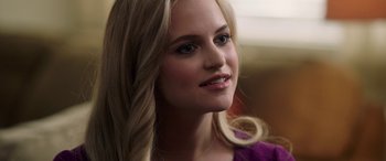 Movie still from “Bombshell” (2019), directed by Jay Roach – A beautiful young lady with long blonde hair and blue eyes; Close Up shot, Over the shoulder angle
