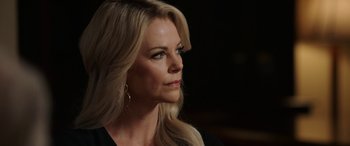 Movie still from “Bombshell” (2019), directed by Jay Roach – A woman with long blonde hair looking to her left; Close Up shot, Over the shoulder angle