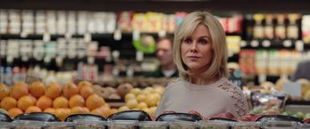 Movie still from “Bombshell” (2019), directed by Jay Roach – A woman standing in front of a display of fruits; Close Up shot, Over the shoulder angle